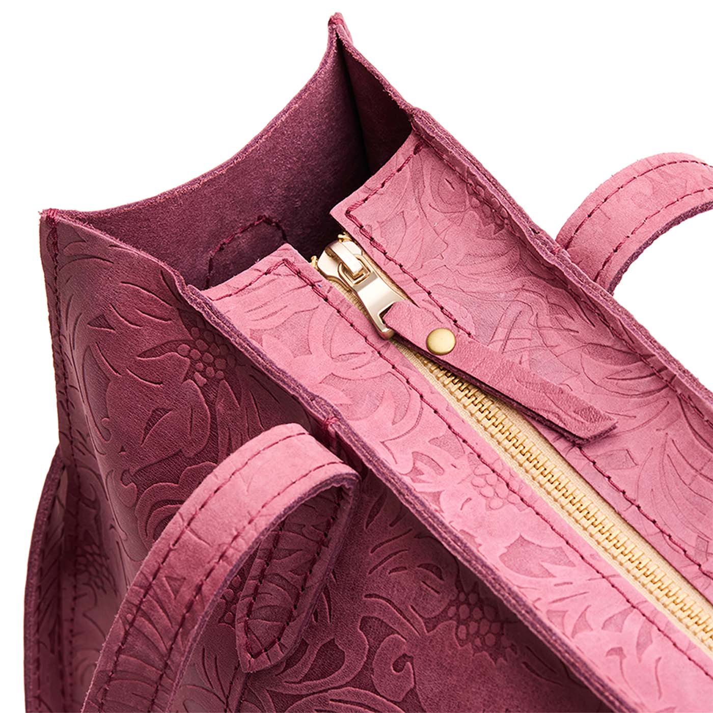 Hollyhock | Close-up of zipper top on structured wide embossed leather tote bag with overlapping panels and crossbody strap