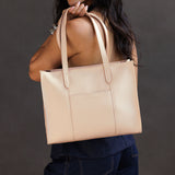 Moonflower East/West | Model wearing structured wide tote bag with overlapping panels and crossbody strap