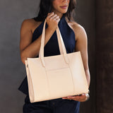 Moonflower East/West | Model wearing structured wide tote bag with overlapping panels and crossbody strap