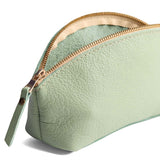 Pistachio | Spacious leather makeup bag with curved seams and top zipper