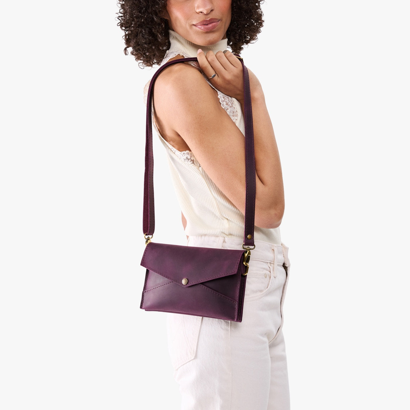 Larkspur | Model holding envelope shaped clutch wallet with crossbody strap