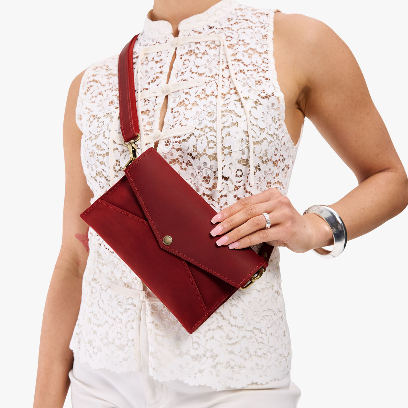 Phoenix | Model holding envelope shaped clutch wallet with crossbody strap