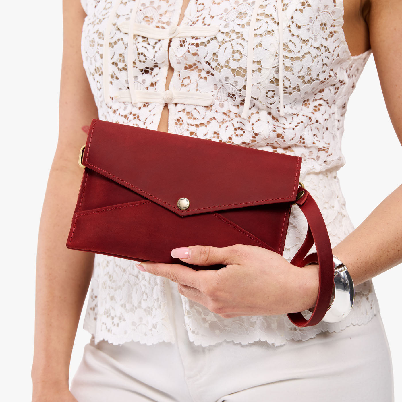 Phoenix | Model holding envelope shaped clutch wallet with crossbody strap