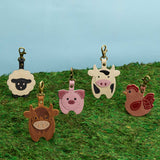 All Variants | Farm animal shaped keychains standing in grass