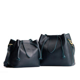 Boreal | Small and large symmetrical leather bags with leather drawstring closure and adjustable shoulder strap