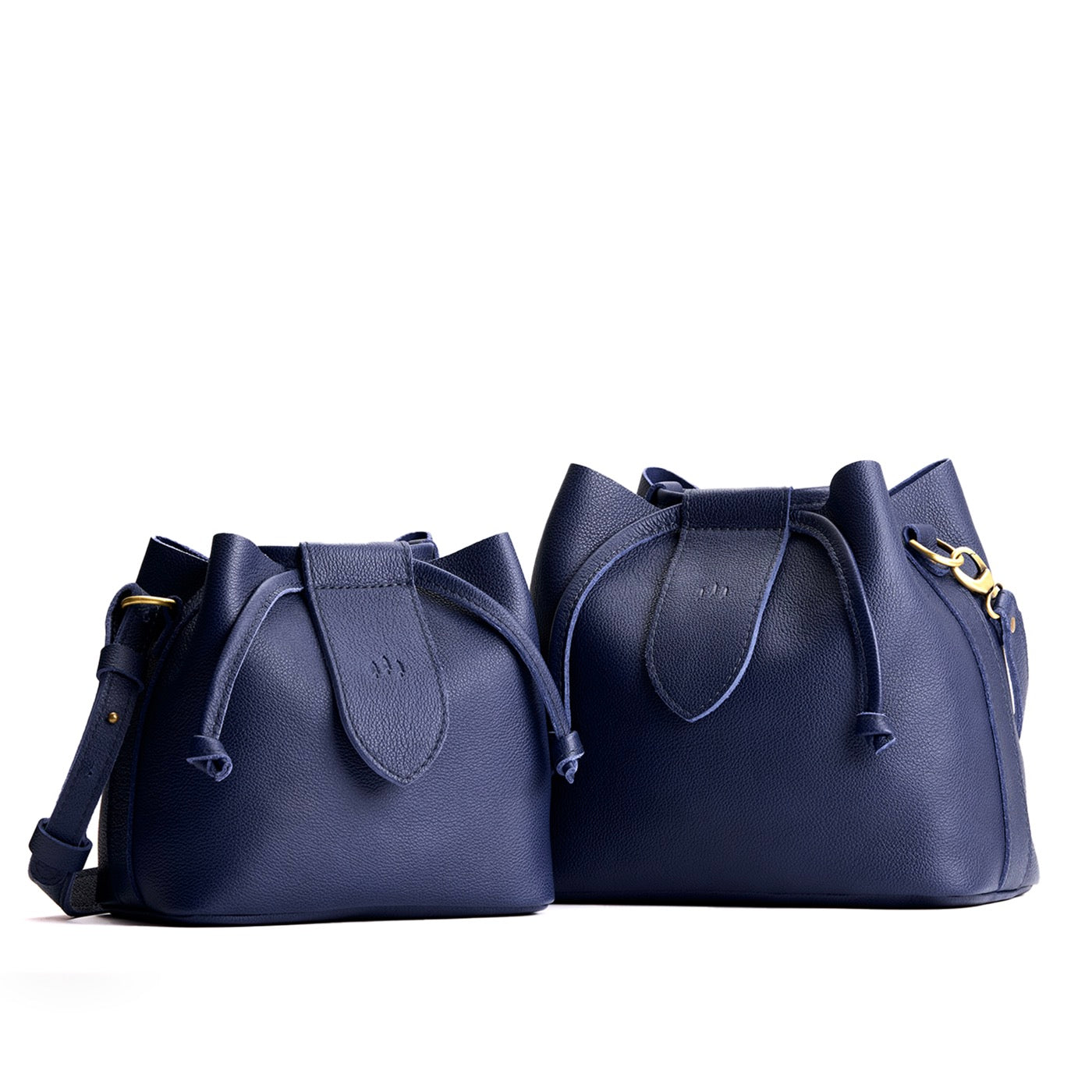 Cobalt | Small and large symmetrical leather bags with leather drawstring closure and adjustable shoulder strap