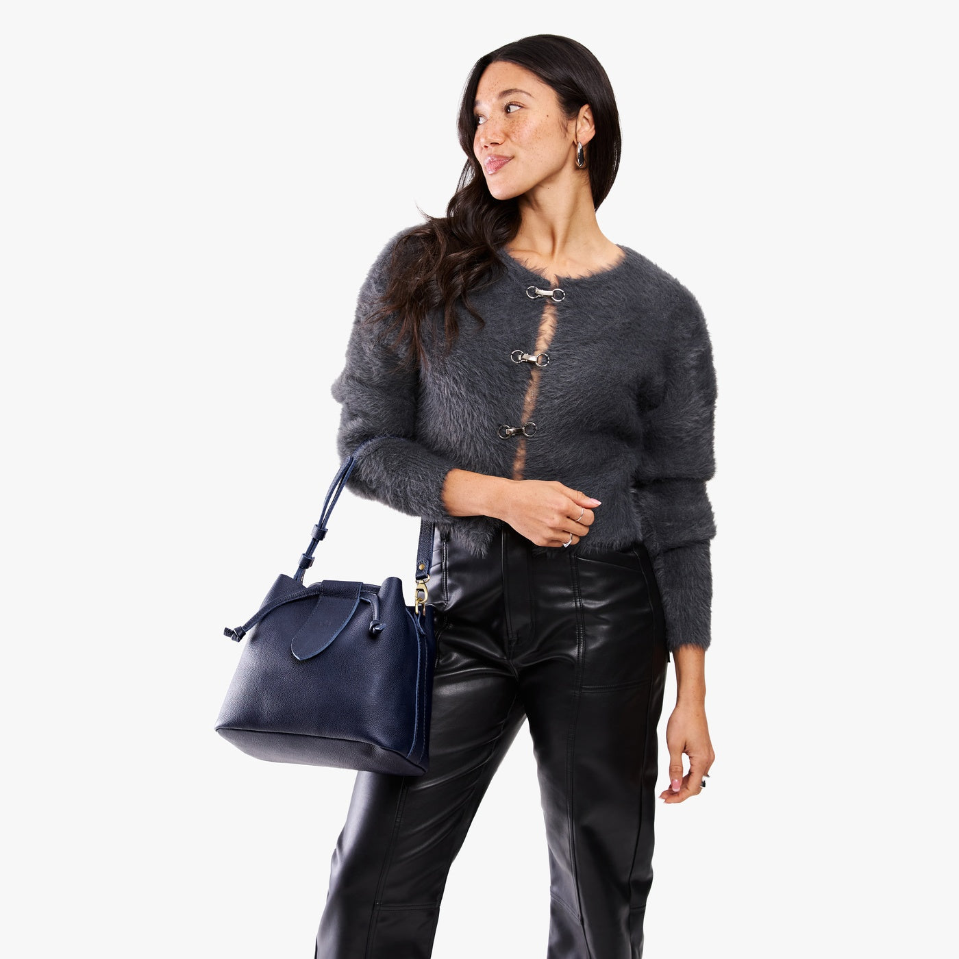 Cobalt*Large | Model holding symmetrical leather bag with leather drawstring closure and adjustable shoulder strap