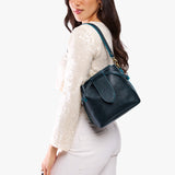 Boreal Small | Model wearing symmetrical leather bag with leather drawstring closure and adjustable shoulder strap