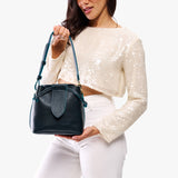 Boreal Small | Model holding symmetrical leather bag with leather drawstring closure and adjustable shoulder strap