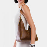 Asheville | Model wearing structured hobo shoulder bag with adjustable strap and magnetic closure