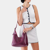Lollipop | Model holding structured hobo shoulder bag with adjustable strap and magnetic closure