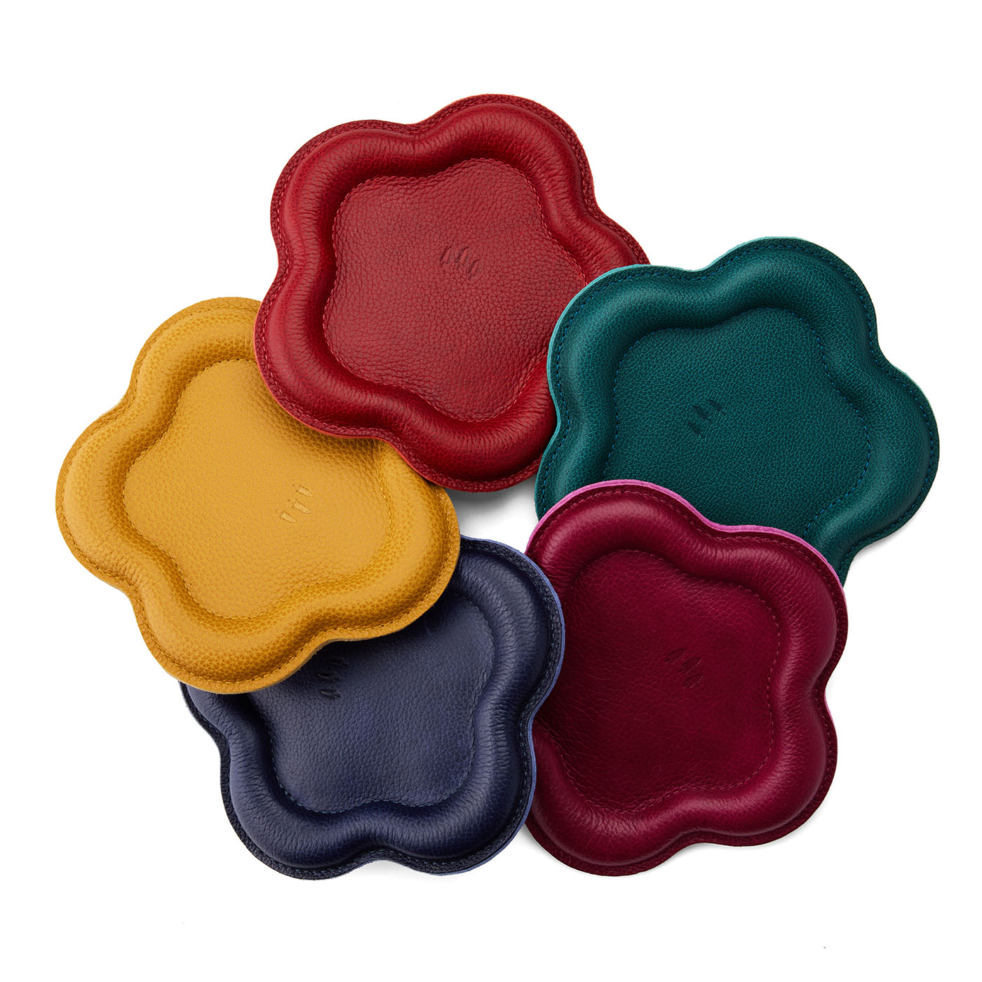 All Variants | Five colorful leather coasters in red, yellow, blue, green, and purple on a white background