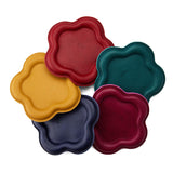 All Variants | Five colorful leather coasters in red, yellow, blue, green, and purple on a white background