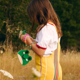 All Variants | Child in nature holding a Froggy Pouch in the color Jolly Green