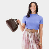 Coldbrew Large | A large bowler styled bag with a crossbody strap being held by a model 