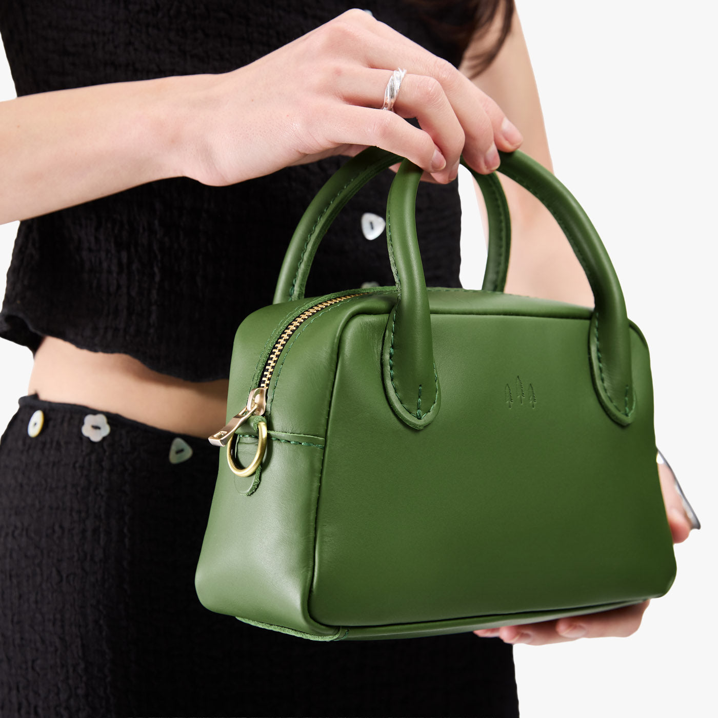 Cactus*Small | A large bowler styled bag with a crossbody strap being worn by a model in a black outfit