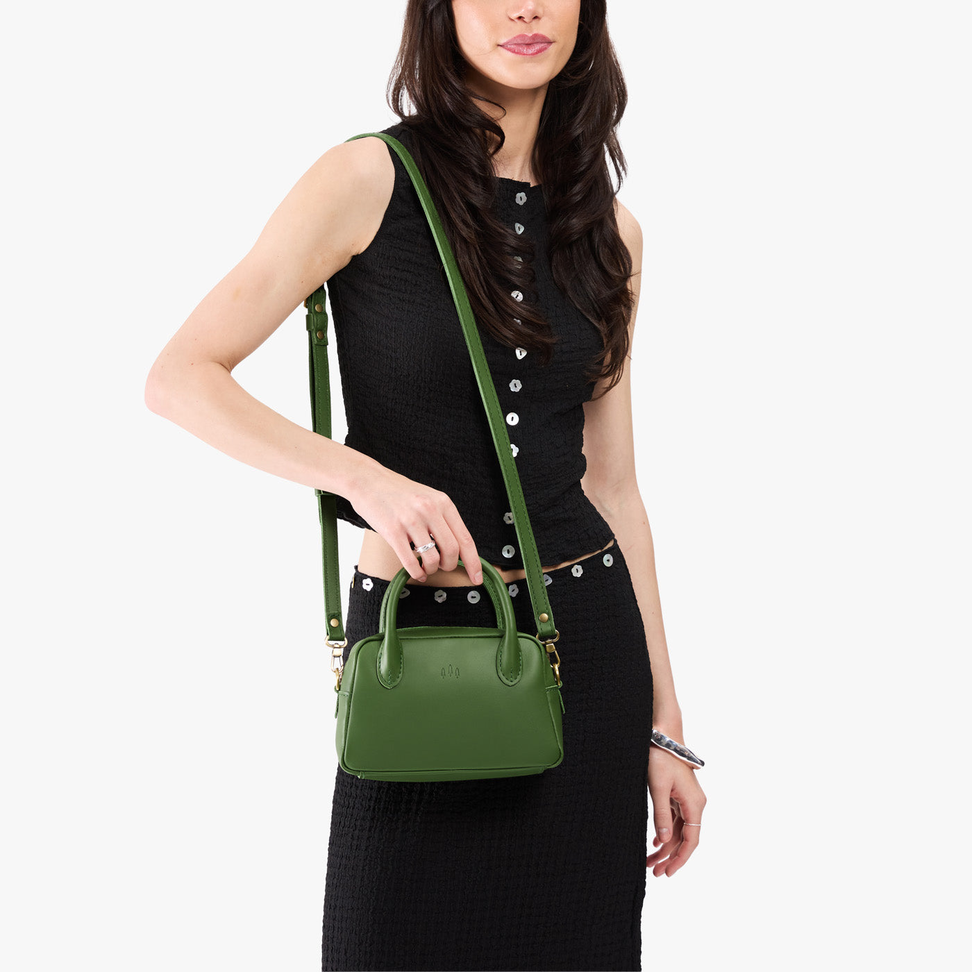 Cactus*Small | A large bowler styled bag with a crossbody strap being worn by a model in a black outfit