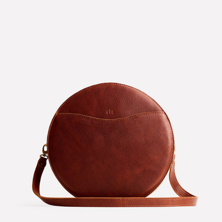 Nutmeg | Large circle shaped leather bag with top zipper and carrying strap