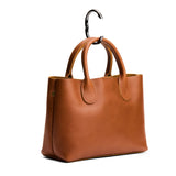Gunmetal | Circular metal purse hanger on a bag