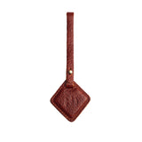 Nutmeg | Rhombus-shaped leather tag with a strap and debossed PLG design