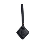 Pebbled--black | Rhombus-shaped leather tag with a strap and debossed PLG design