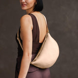 Moonflower Large | Model wearing half circle shaped sling bag