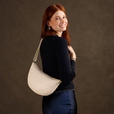 Pebbled Bone Large | Model wearing half circle shaped sling bag