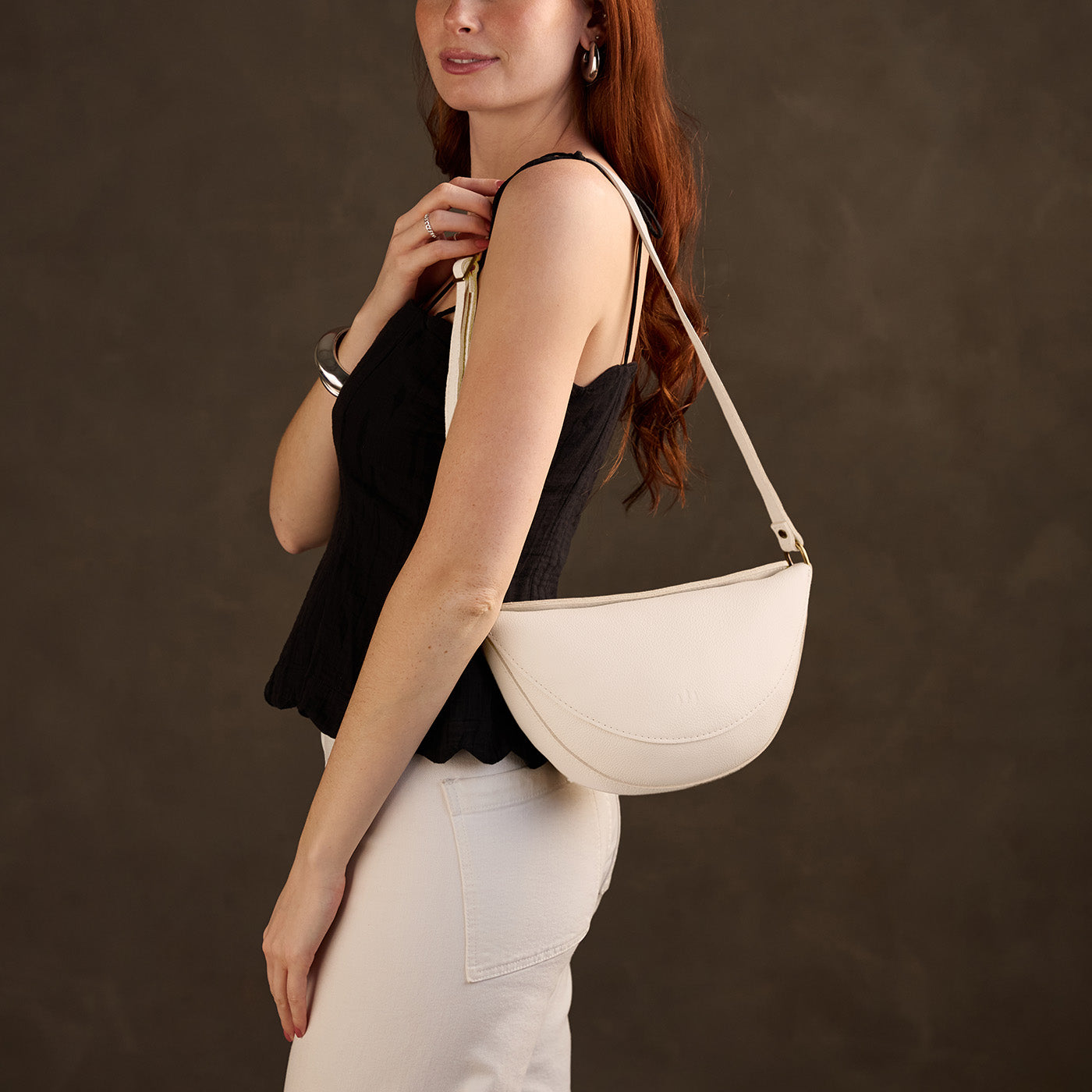 Pebbled Bone*Medium | Model wearing half circle shaped sling bag