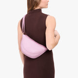 Pinkaboo Medium | Model wearing half circle shaped sling bag