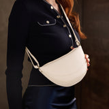 Pebbled Bone Small | Model wearing half circle shaped sling bag