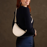 Pebbled Bone Small | Model wearing half circle shaped sling bag