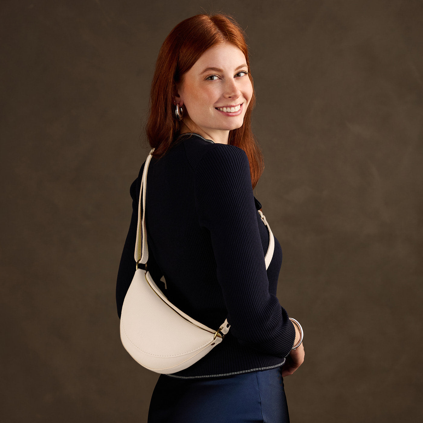 Pebbled Bone*Small | Model wearing half circle shaped sling bag