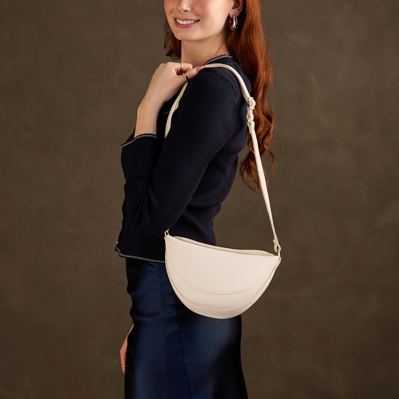 Pebbled Bone*Small | Model wearing half circle shaped sling bag