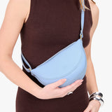 Skyway Small | Model wearing half circle shaped sling bag