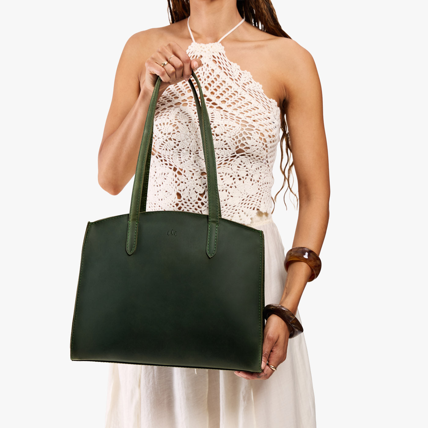 Evergreen*Large | Model carrying leather tote bag with handles, adjustable crossbody strap, and two back pockets