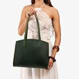 Evergreen Large | Model carrying leather tote bag with handles, adjustable crossbody strap, and two back pockets