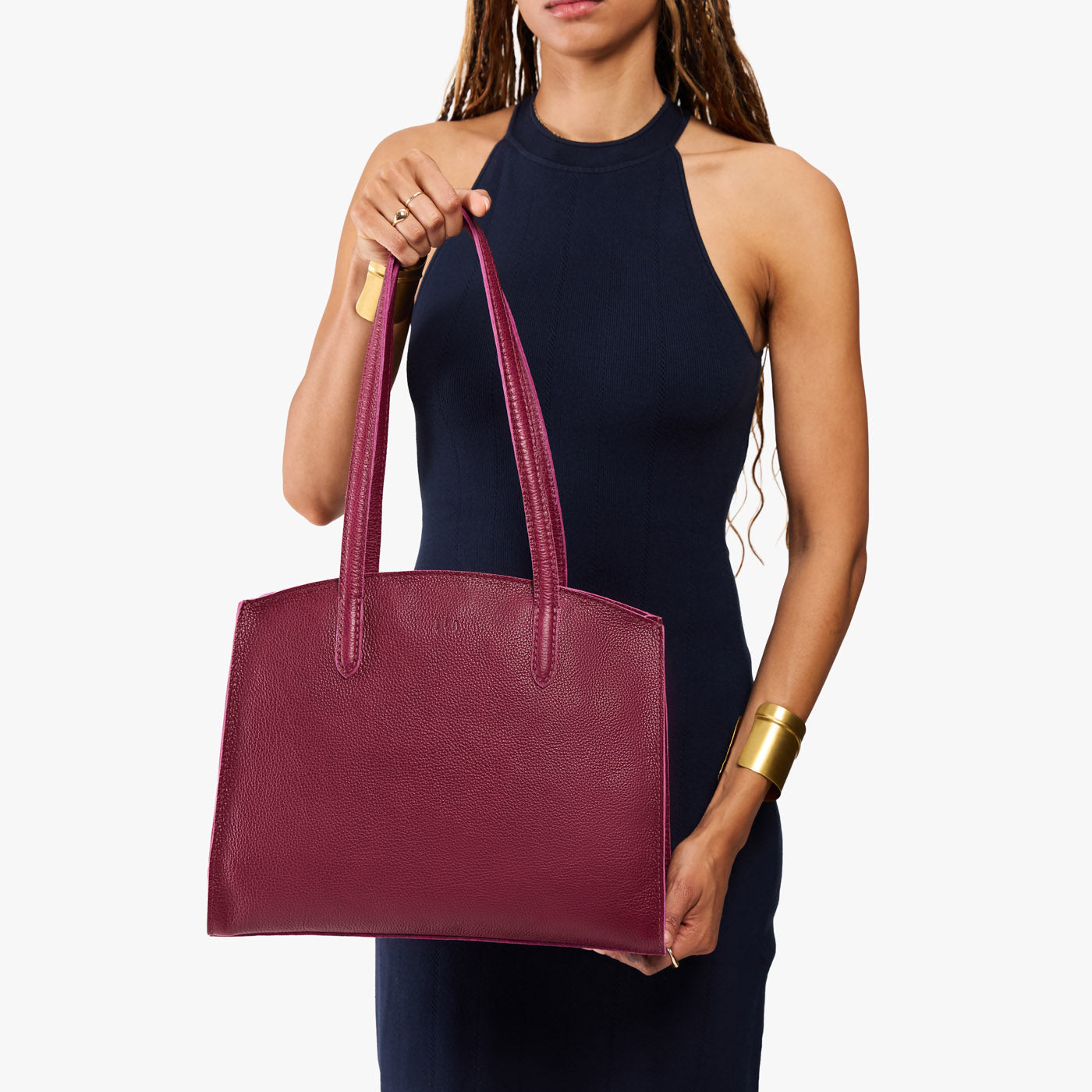 Orchid*Large | Model carrying leather tote bag with handles, adjustable crossbody strap, and two back pockets