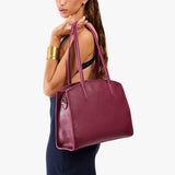 Orchid Large | Model carrying leather tote bag with handles, adjustable crossbody strap, and two back pockets