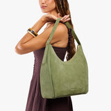 Laurel Large | Model holding u-shaped, flat-bottomed leather shoulder bag with adjustable strap