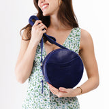 Cobalt Large | Model wearing circle shaped crossbody bag with top zipper