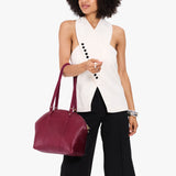 Orchid Large | Model holding a half circle crossbody bag with handles and removable crossbody strap