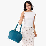 Planetary Large | Model holding a half circle crossbody bag with handles and removable crossbody strap