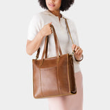 Asheville North/South | Model wearing structured large tote bag with overlapping panels and crossbody strap