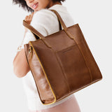 Asheville North/South | Model wearing structured large tote bag with overlapping panels and crossbody strap