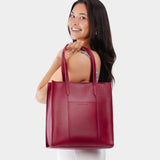 Berry Good North/South | Model wearing structured large tote bag with overlapping panels and crossbody strap