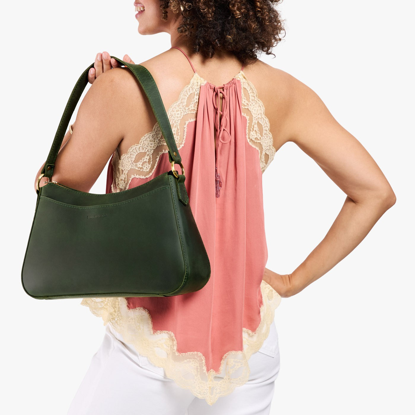 Evergreen*Large | Model holding a bean shaped shoulder bag with a zipper closure
