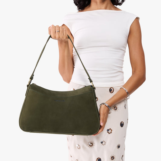 Verdant*Large | Model holding a bean shaped shoulder bag with a zipper closure