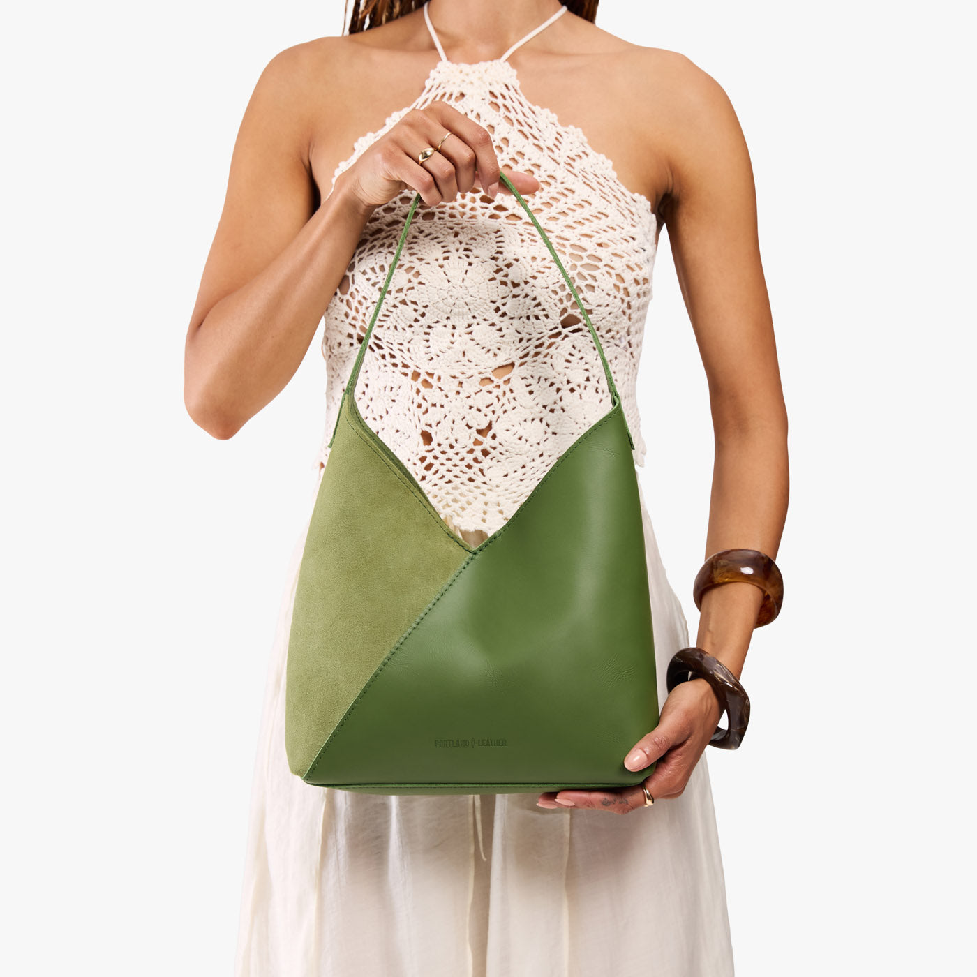 Dryland Green*Large | Model holding mid-size shoulder bag with magnetic snap closure