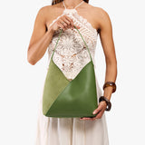Dryland Green Large | Model holding mid-size shoulder bag with magnetic snap closure