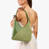 Dryland Green Large | Model holding mid-size shoulder bag with magnetic snap closure
